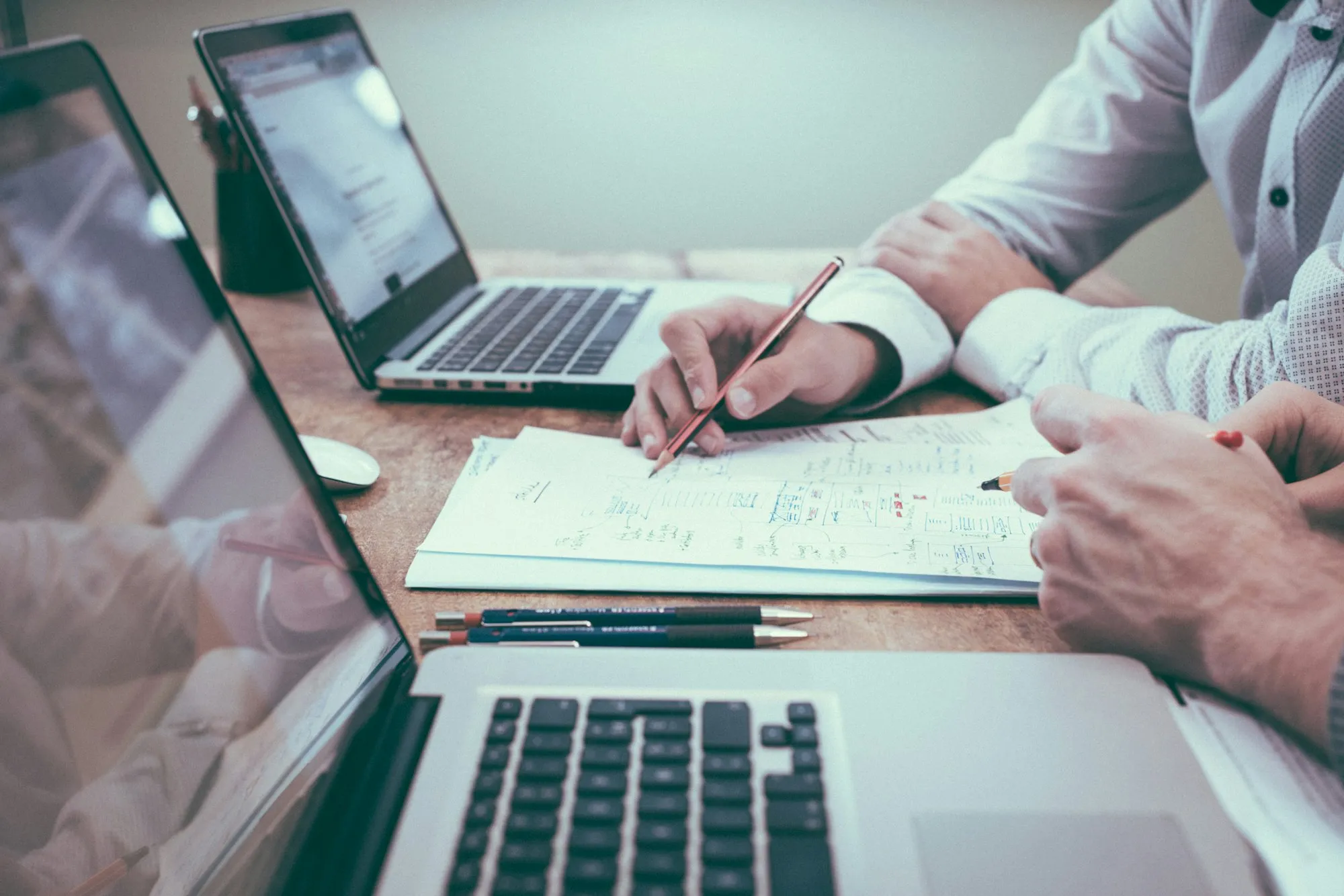 An Electrical Planning Report and supporting strata documents on a desk